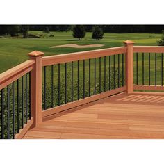 a wooden deck with wrought iron railings and green golf course in the back ground