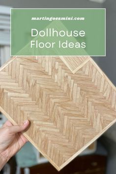 a person holding up a piece of wood with the words dollhouse floor ideas on it