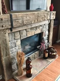 a living room with a stone fireplace and tv on top of the mantels