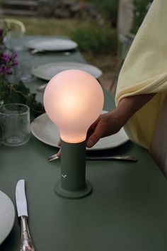 a table with plates and utensils on it that is being held by a person