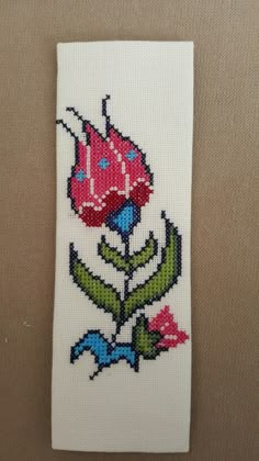 a cross stitch bookmark with a flower on it