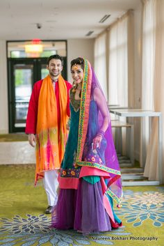 a man and woman dressed in colorful clothing