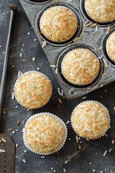 several muffins sitting in a tray on top of a table