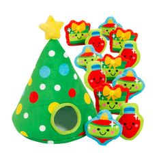 a green christmas tree with lots of decorations on it and some cookies in the shape of santa hats