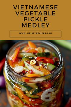 a glass jar filled with pickles and vegetables