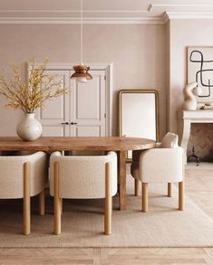 a dining room with beige walls and white chairs