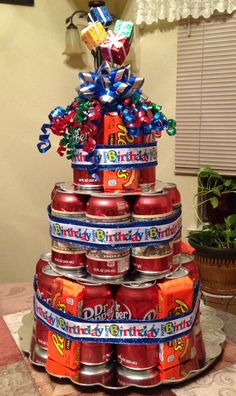 a birthday cake made out of soda cans