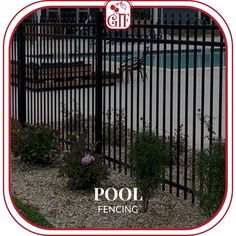 the pool fence is surrounded by flowers and plants