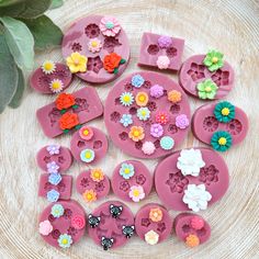 several flower molds sitting on top of a wooden table