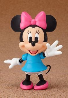 a minnie mouse figurine with a pink bow on it's head and blue dress