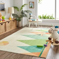 a child's play room with toys and rugs on the floor, including a rocking horse