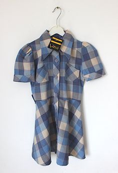 "FRENCH VINTAGE 70's, stunning plaid belted dress, midweight Tergal fabric ( polyester blend ), blue colors, wide pointed collar, breast pockets, buttoned on the front,  belt to tie, made in Belgium. Estimated size 6 years Length 23,2\" / Underarms 13,4\"  Vintage condition level 5, new old stock ( belt is messing and can be easily replaced ) We assess the condition of our vintage items on a scale from 0 to 5. Level 5 corresponds to an almost new vintage condition. Any defects are systematically Fitted Vintage Plaid Dress, Retro Plaid Mini Dress, Fitted Retro Plaid Dress For Fall, Vintage Plaid Short Sleeve Dress, Fitted Plaid Collared Dress, Collared Fitted Plaid Dress, Fitted Collared Plaid Dress, Vintage Plaid Dress For Work, Fitted Vintage Plaid Dress With Buttons