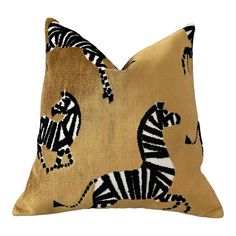 a gold pillow with zebras on it