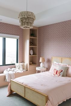 a bed room with a neatly made bed next to a window and a book shelf