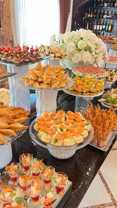 an assortment of appetizers and desserts on display in a buffet style setting