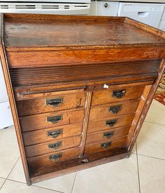 an old wooden cabinet with many drawers