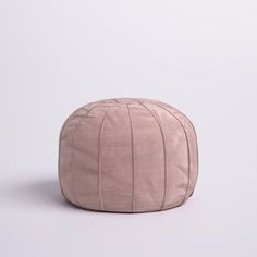 a round pink poufce on a white background