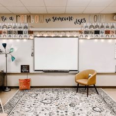 a room with a rug, chair and whiteboard