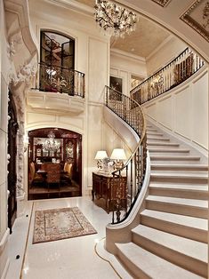 an elegant foyer with chandelier and staircase leading to the second floor bedroom area