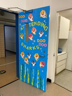 a door decorated to look like a shark and other fish in the ocean with words on it