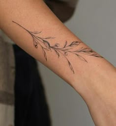 a woman's arm with a flower tattoo on the left side of her arm