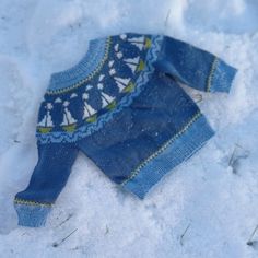 a blue sweater laying in the snow