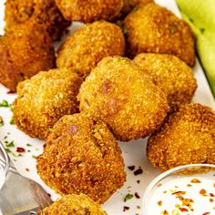 some food is on a white plate and next to a bowl of ranch dressings