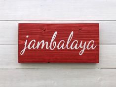 a wooden sign that says jambaalaya on it's red wood planks