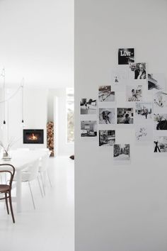 a dining room table with chairs and pictures on the wall above it that have been cut into squares