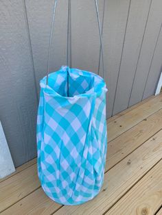 a blue and white bag sitting on top of a wooden floor next to a door