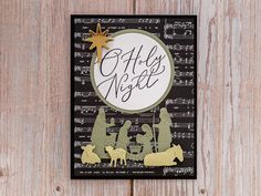 a christmas card with nativity scene and star on it, hanging from a wooden wall