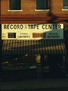 an old record and tape center on the side of a building