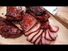 sliced meat sitting on top of a wooden cutting board