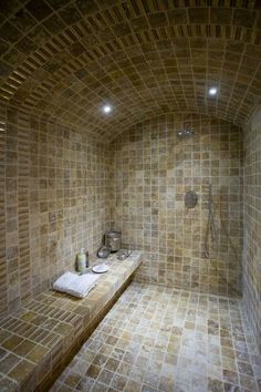 a bathroom with tiled walls and flooring in the shower area is shown here, there are two sinks on either side of the bathtub