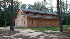 a large wooden building sitting in the middle of a forest