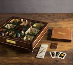 a wooden table topped with cards and a board game set on top of it's side