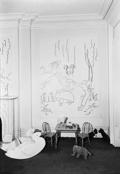 an old black and white photo of children's room with chalk drawings on the wall