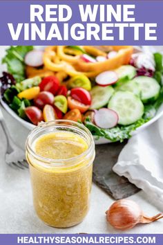 red wine vinaigrette in a jar next to a salad