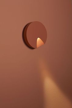 a round hole in the wall with a light coming from it's center point