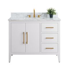 a bathroom vanity with marble top and gold handles on it's drawers, along with a potted plant