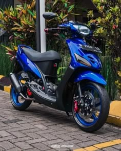 a blue and black motorcycle parked on the street