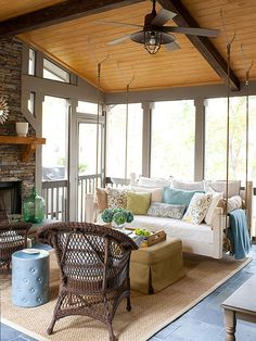 a living room filled with furniture and a fire place in the middle of an open floor plan