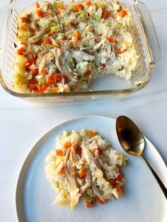 a casserole dish with chicken, rice and carrots on a white plate