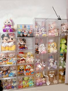 a bunch of small stuffed animals are stacked on top of each other in plastic bins