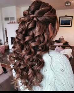 the back of a woman's head with long curly hair and curls in it