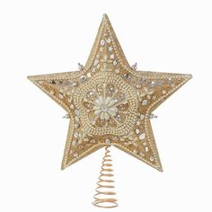 a gold star decoration hanging on a white wall