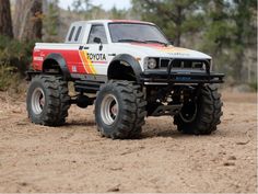 a toy truck is parked in the dirt