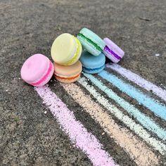 colorful macaroons are lined up on the pavement