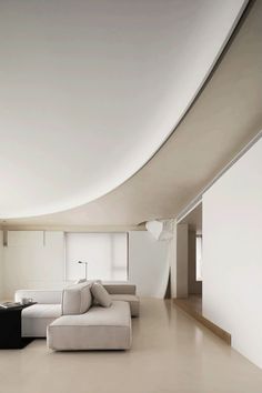 a living room filled with furniture and white walls