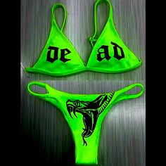 Brand New Boutique Item. Sexy Bright Neon Green Colored Two Piece String Bikini Set With The Word “Dead” Printed In Black Lettering Across The Triangle Bikini Top And A Graphic Of A Snake With Its Mouth Open On The Front Of The Bottoms. Top Features Adjustable Straps, Removable Padding, & Clips Behind The Back. Fully Lined. Material Is Ribbed. See Pictures For Details. Note: The Top Runs Small, But The Bottoms Do Not Small: Bust: 25.2” Waist: 24.4” Medium: Bust: 26.7” Waist: 25.9” Large: Bust: 2 Summer Swimwear For Club And Beach Season, Poison Snakes, Goth Bathing Suit, Holiday Bikinis, Blue Bathing Suit, Pole Dancing Clothes, Suit Swimsuit, Reversible Bikinis, Cute Swimsuits